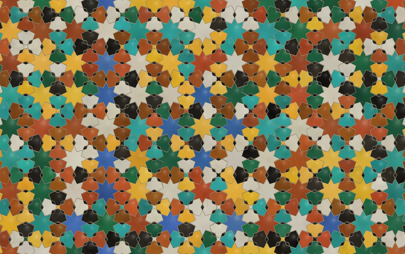 A dense zellige of small cut pieces on a near-black ground: stars in gold, turquoise, terracotta and green, with pale mortar between